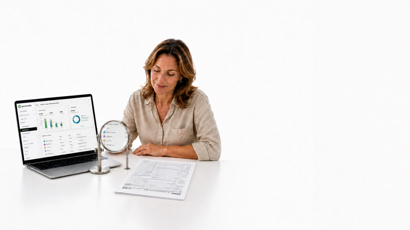 A business owner reviewing QuickBooks and a tax return at her desk