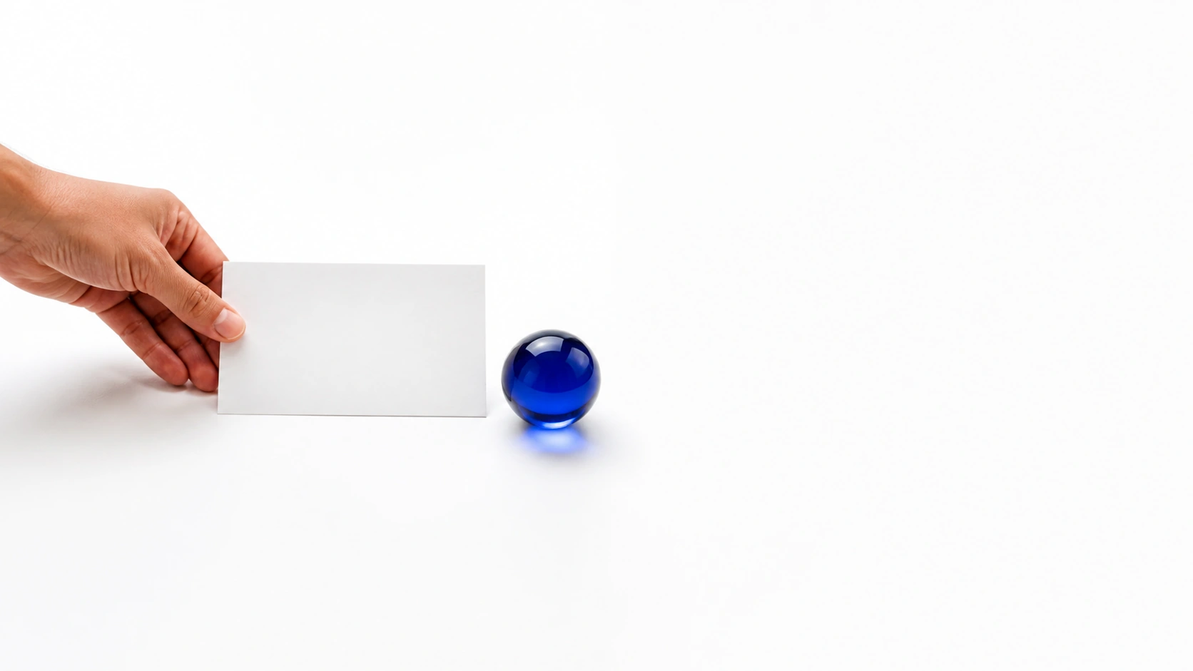 A hand places a question card beside a cobalt Financial Brain.